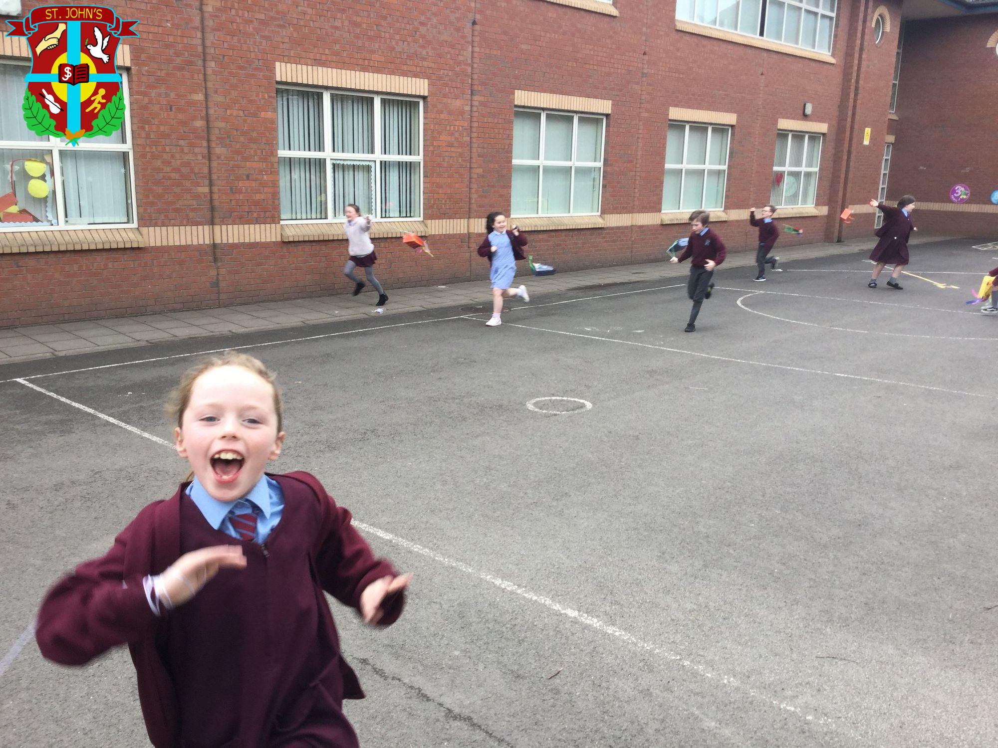 Year 4 children trying out their paper bag kites.