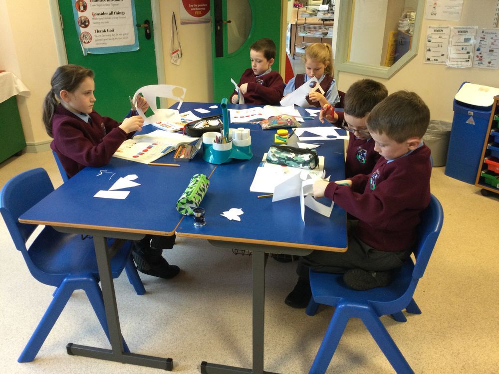 Year 4B investigating  lines of symmetry in 2D shapes